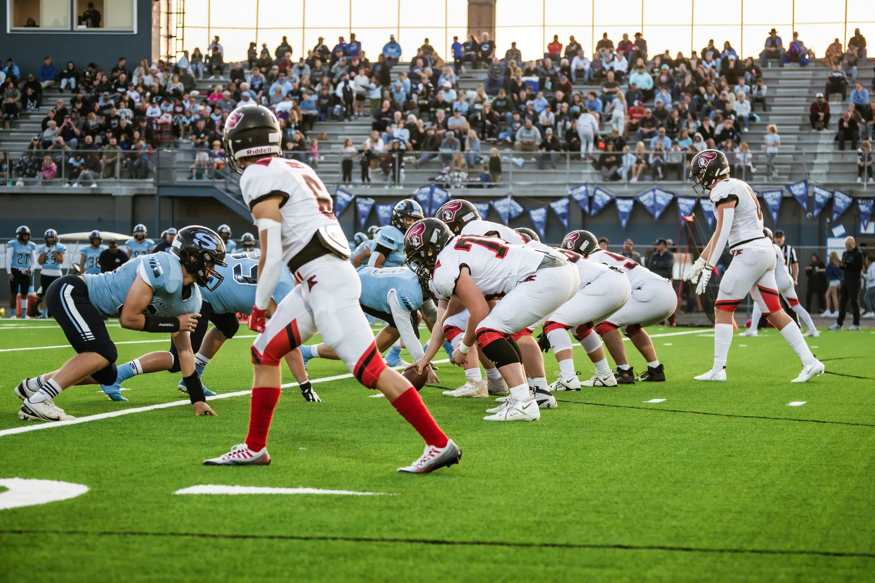 Hawks football team lined up at the line of scrimmage