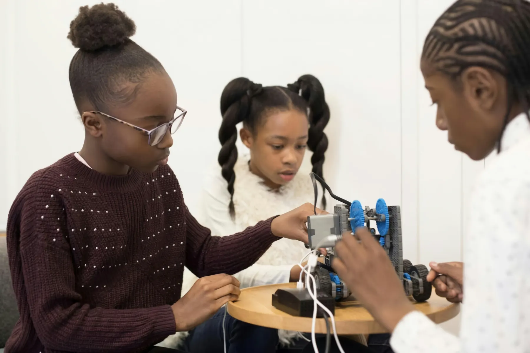 Students building a robot together