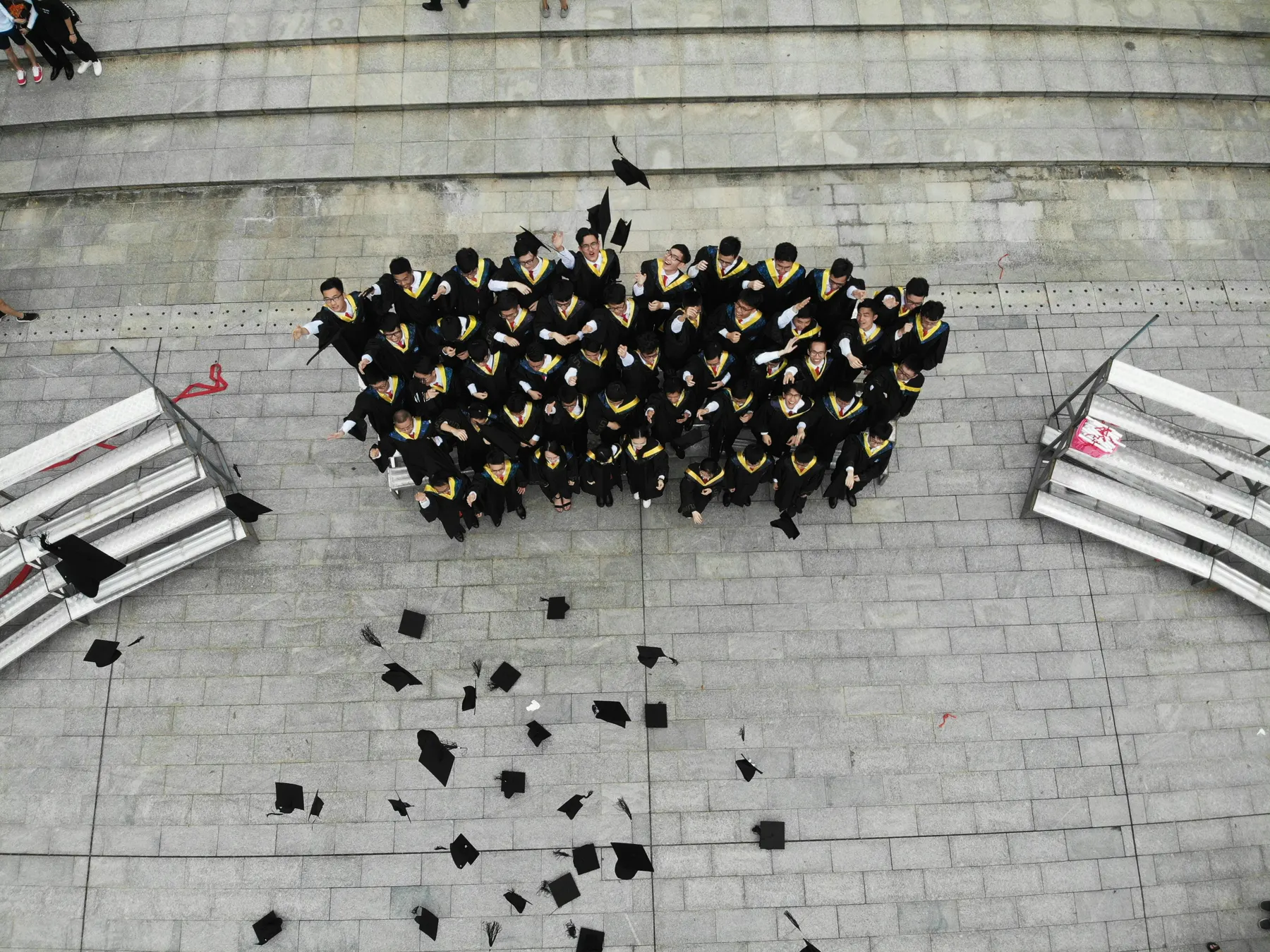 Graduates tossing their caps, seen from above