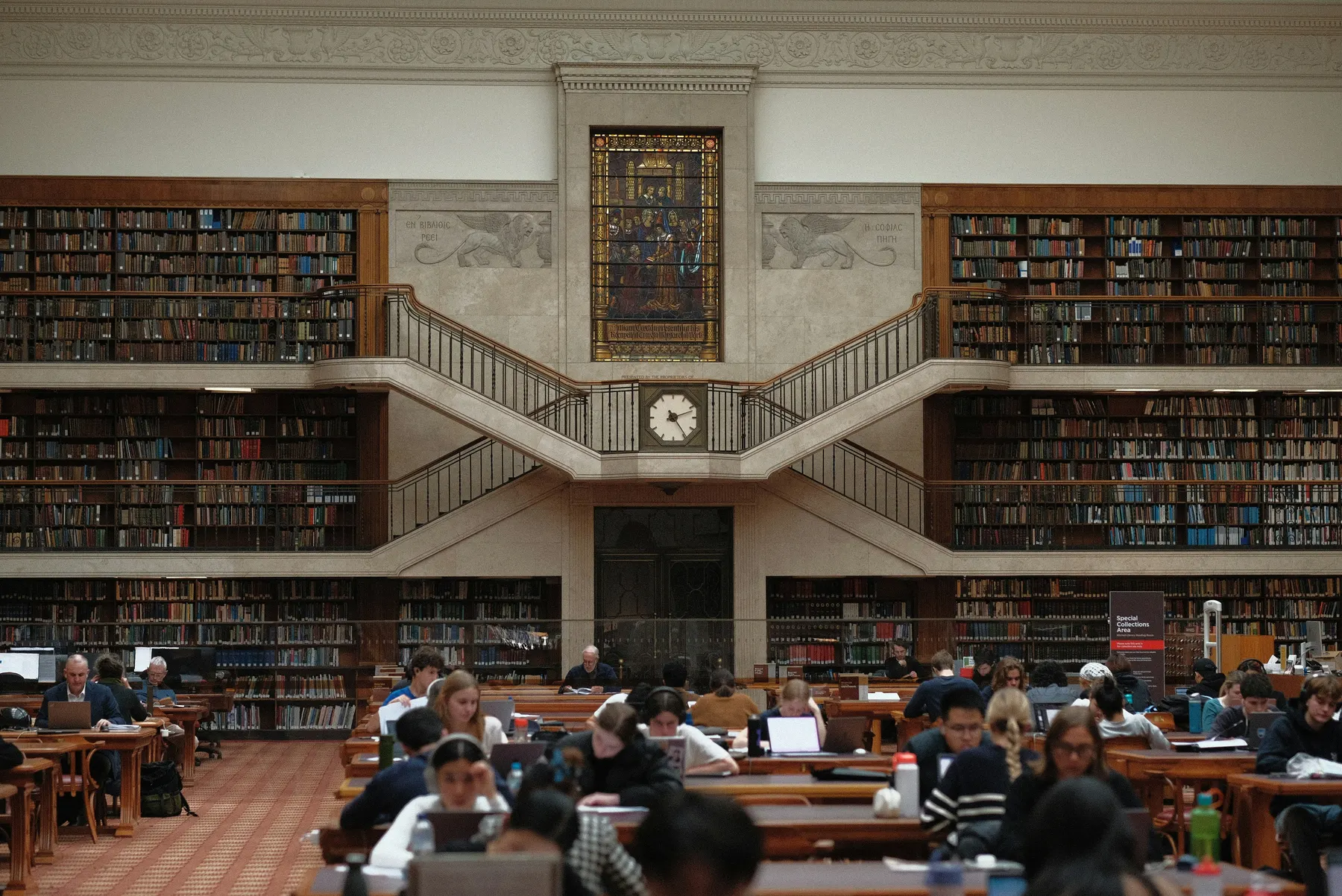 Students studying in a two-story library
