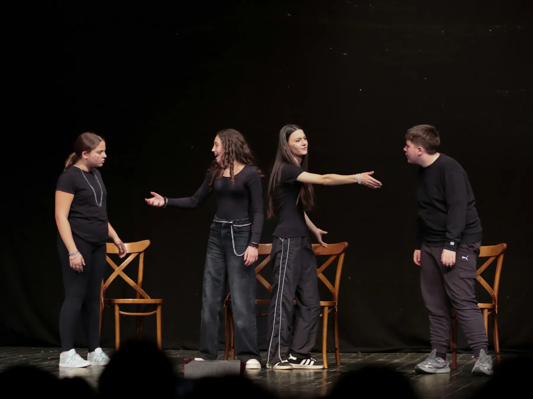 Student actors rehearsing a scene on stage