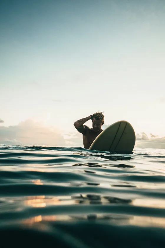 Portrait of a guide sitting on a board in the water